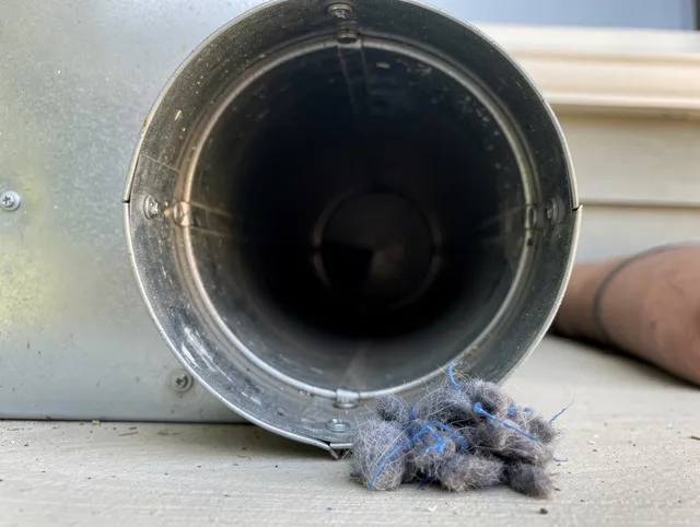 Heath Dryer Vent Cleaning technician using specialized equipment to clear severe dryer vent blockage in Heath